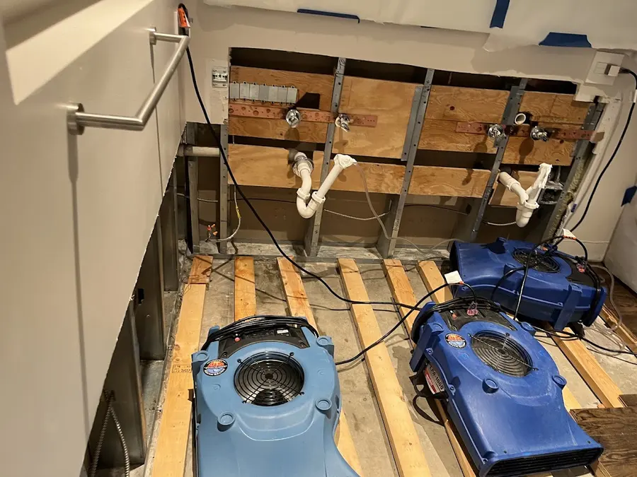 Air movers drying the subfloor under removed kitchen cabinets in Pueblo, CO