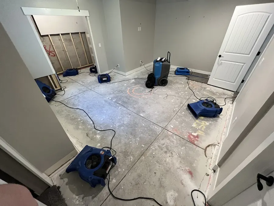 Air movers and a dehumidifier drying an emptied room with the flooring pulled in Pueblo, CO